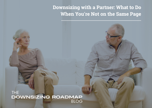 Mature couple sitting together in their living room, having a thoughtful conversation about moving or downsizing.