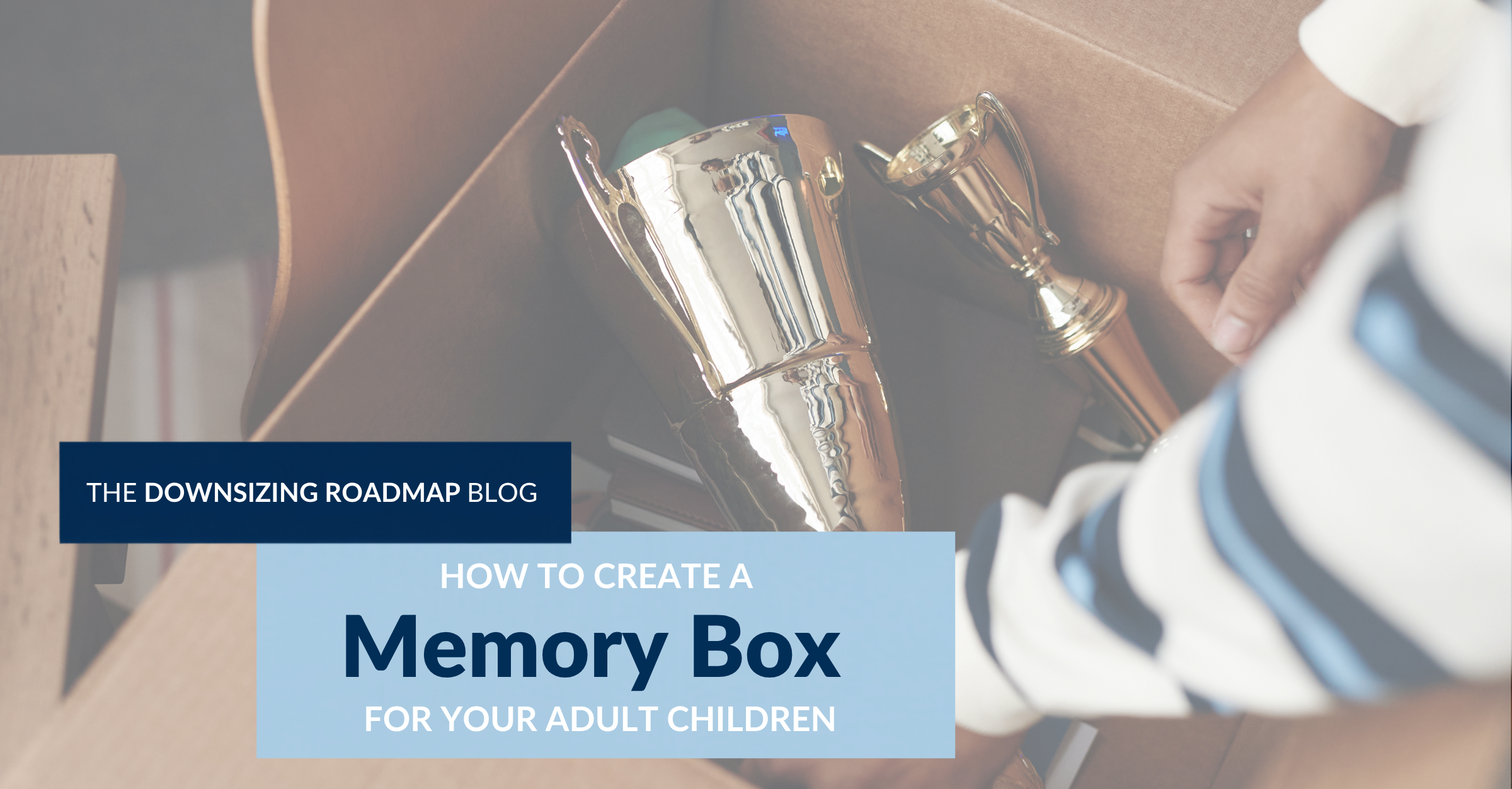 Parent packing a memory box of childhood keepsakes for an adult child