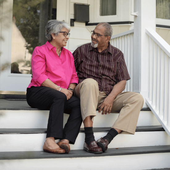 couple sitting on front steps of a home